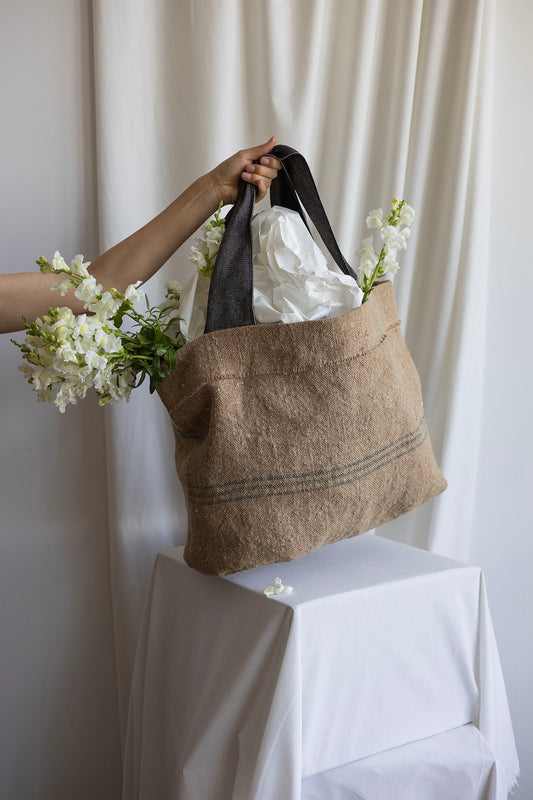 Striped Abundance bag with dark grey shoulder straps